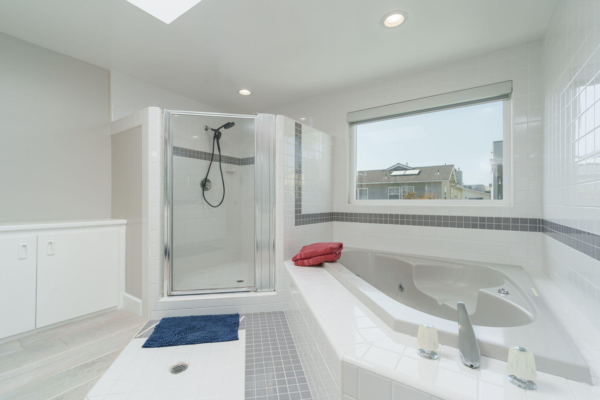 5235 Sealane Way Oxnard, CA 93035 - Photo 22 of 53 a bathroom with a tub shower vanity and a sink