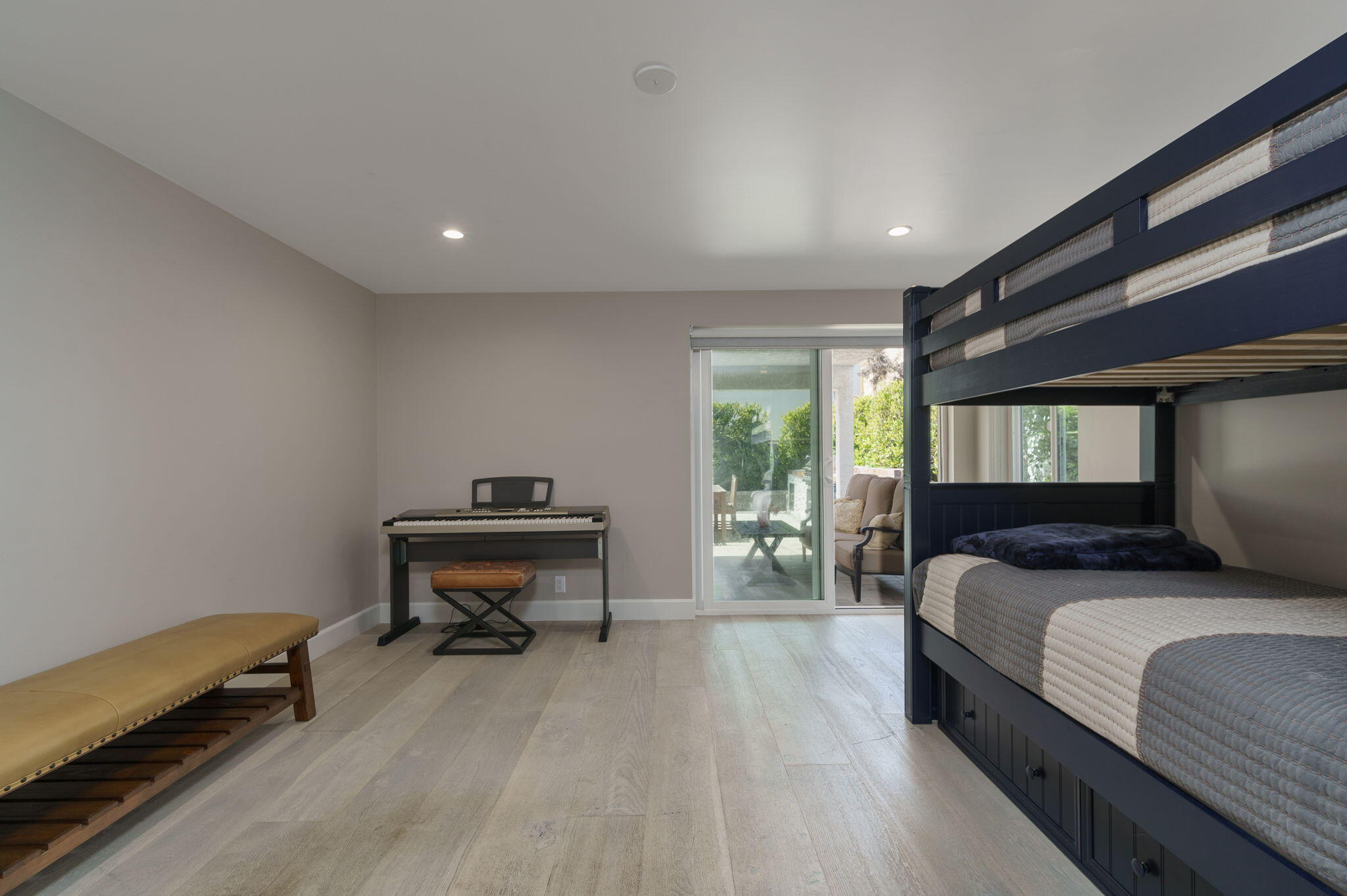 5235 Sealane Way Oxnard, CA 93035 - Photo 34 of 53 a bedroom with a bed and a lounge chair