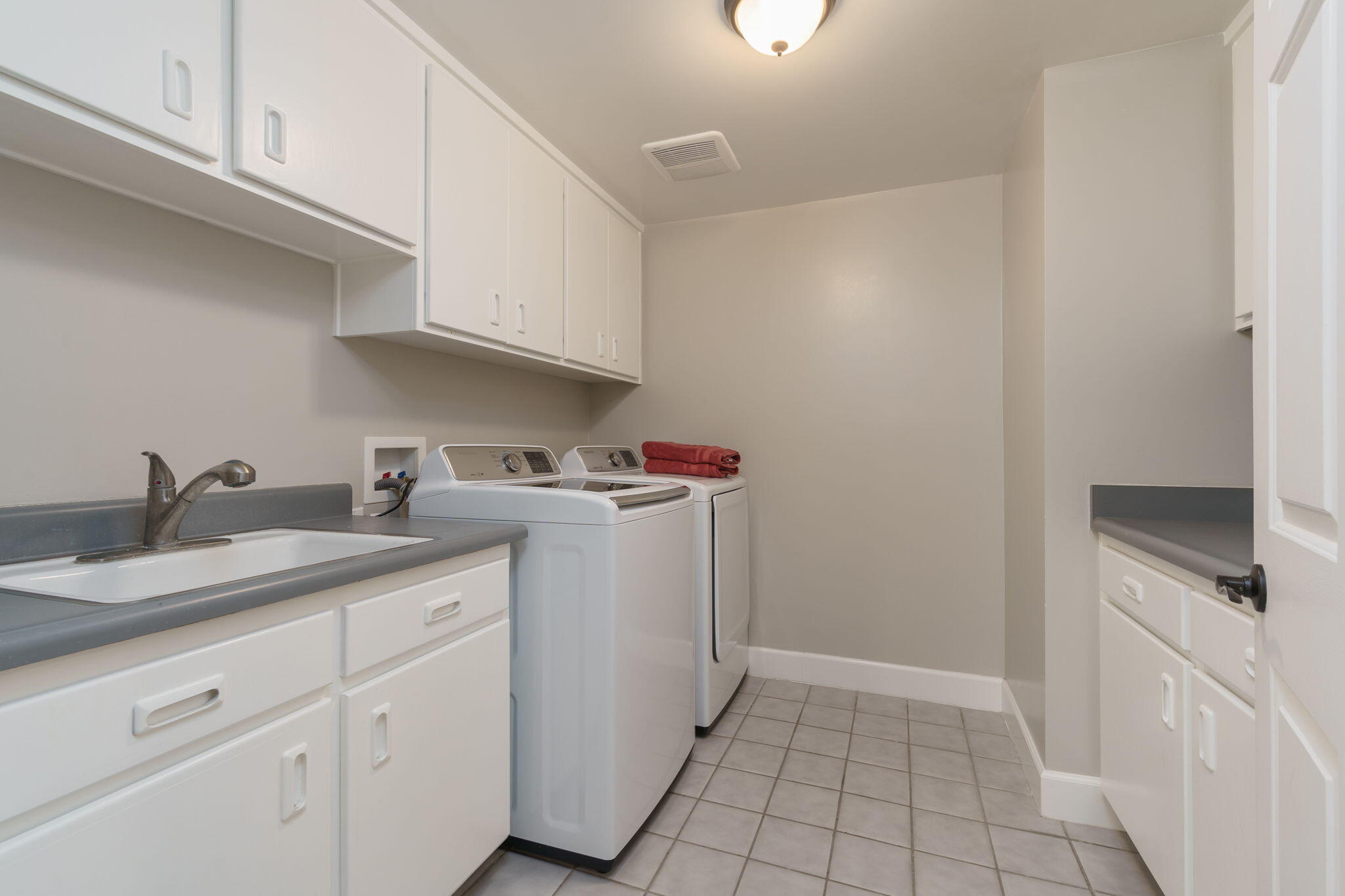 5235 Sealane Way Oxnard, CA 93035 - Photo 46 of 53 a utility room with cabinets washer and dryer