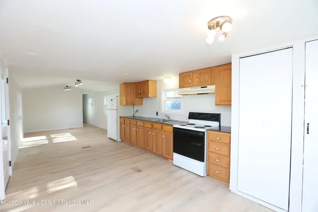 a large kitchen with cabinets and stainless steel appliances