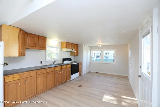 a large kitchen with stainless steel appliances granite countertop a sink and cabinets