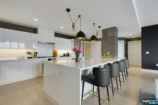 a kitchen with stainless steel appliances kitchen island granite countertop a table and chairs in it