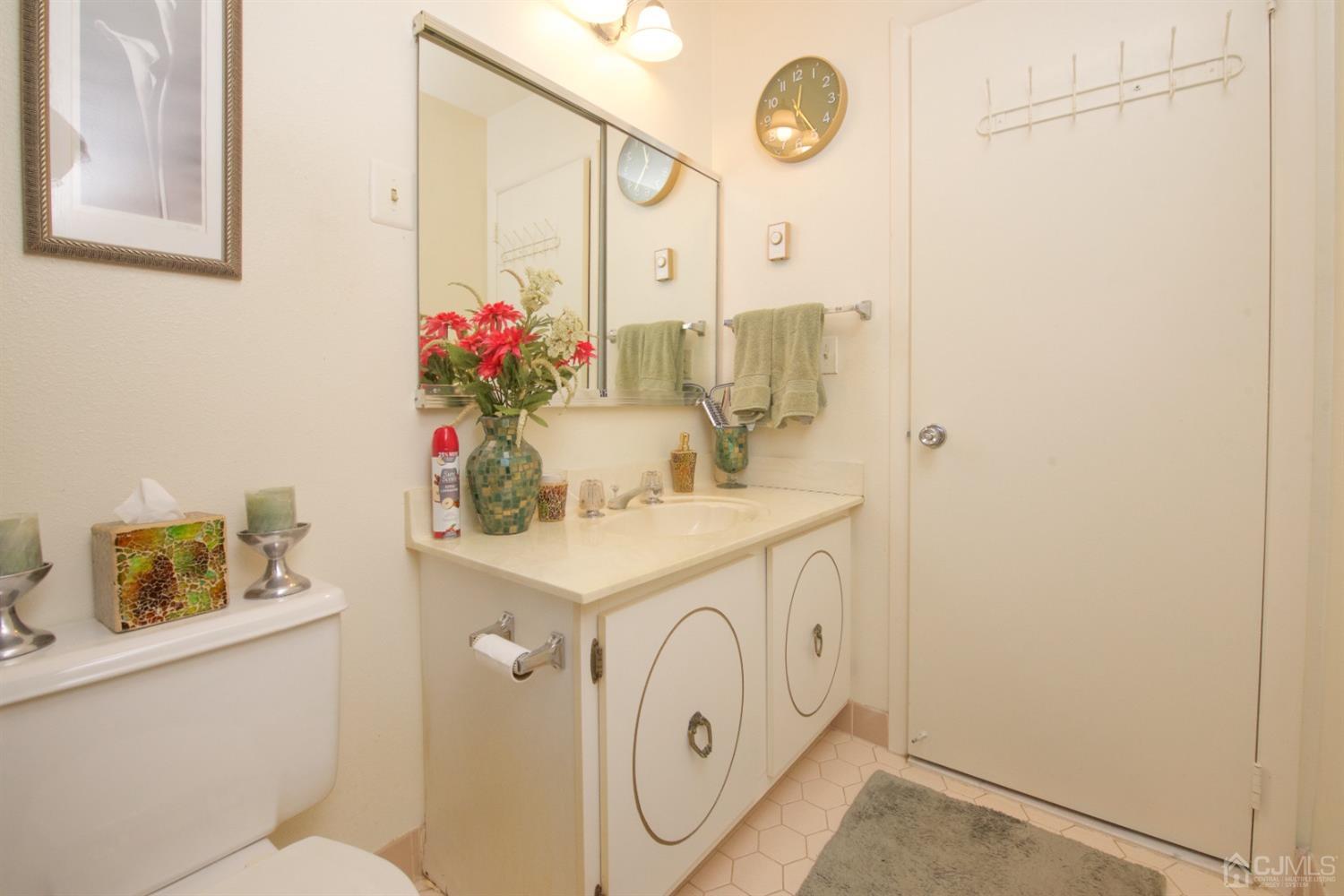 A Pompton Road Monroe Township, NJ 08831 - Photo 15 of 30 a bathroom with a sink a vanity and a mirror