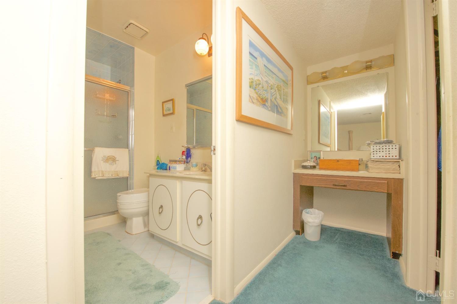 A Pompton Road Monroe Township, NJ 08831 - Photo 21 of 30 a bathroom with a sink a toilet and a mirror