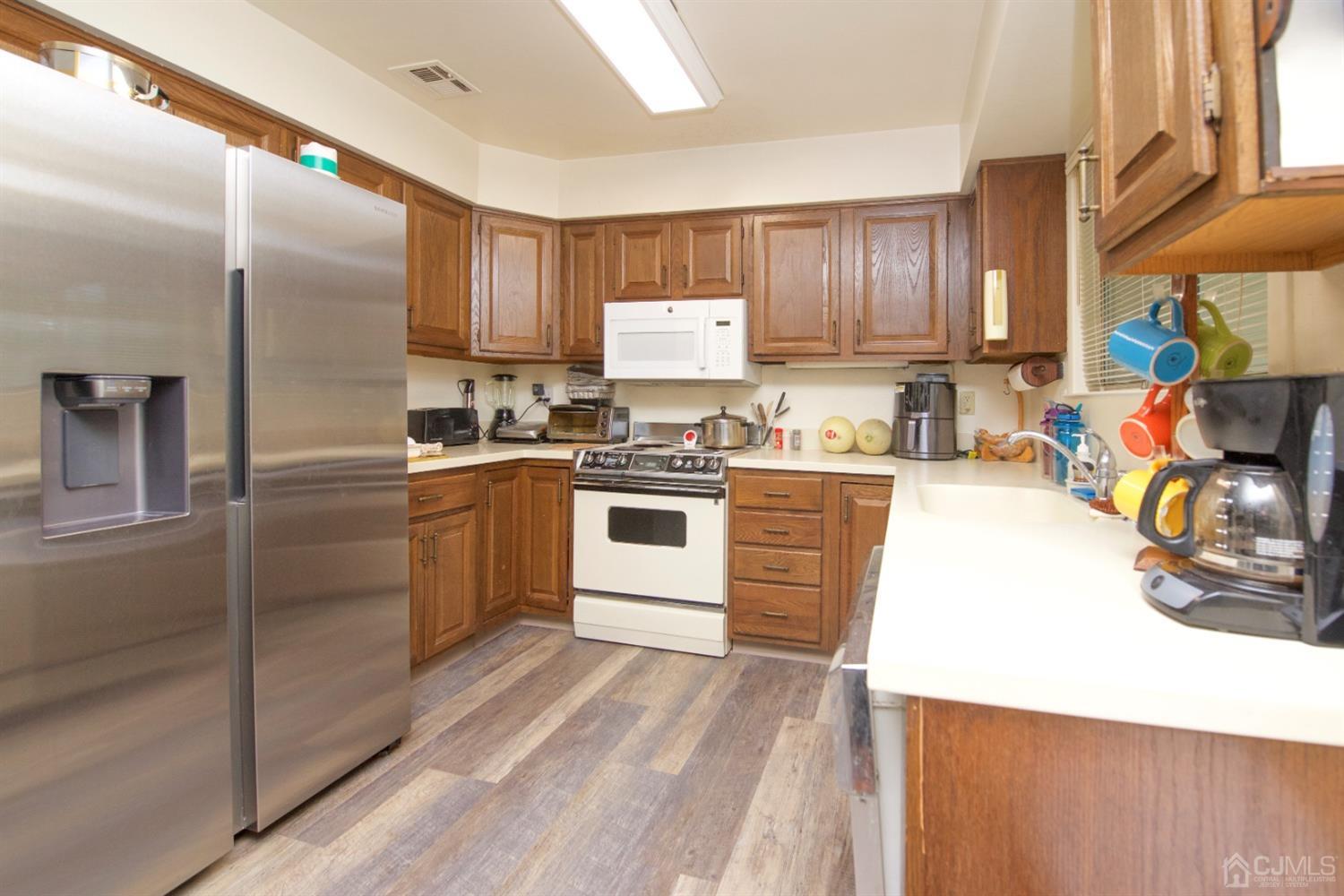 A Pompton Road Monroe Township, NJ 08831 - Photo 8 of 30 a kitchen with stainless steel appliances granite countertop a sink stove and refrigerator