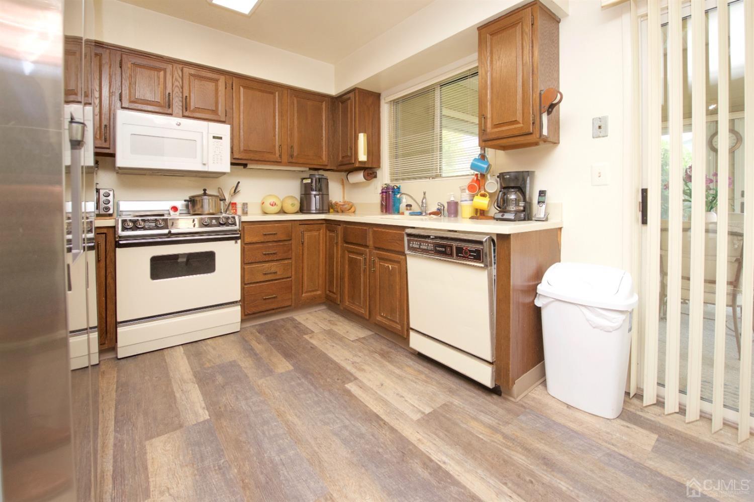 A Pompton Road Monroe Township, NJ 08831 - Photo 10 of 30 a kitchen with a white cabinets and white appliances