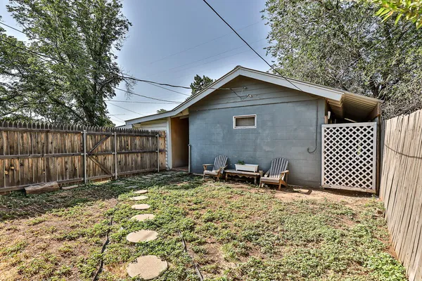 a backyard of a house with table and chairs
