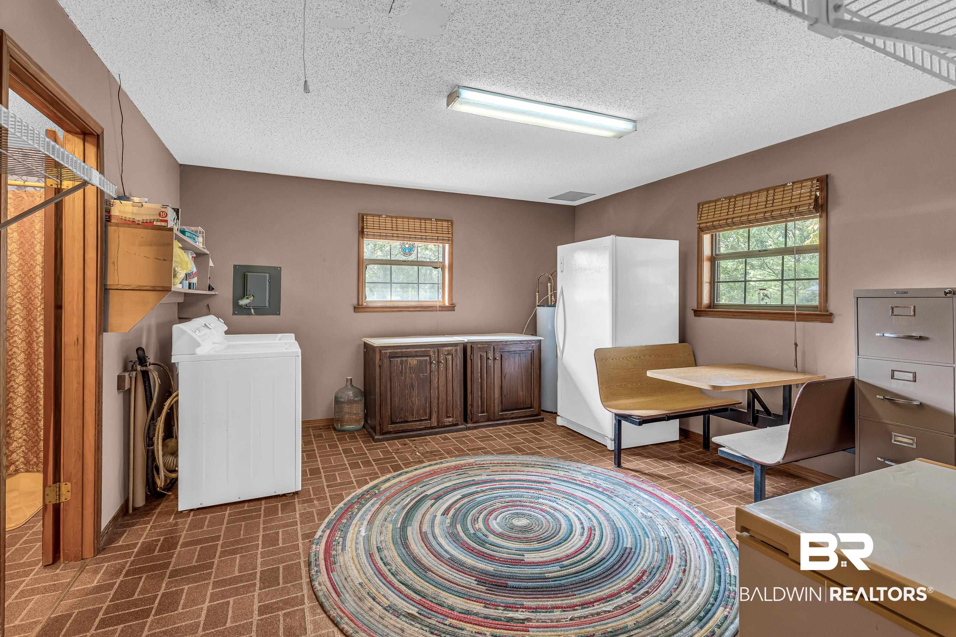 72075 Highway 59 Little River, AL 36550 - Photo 25 of 40 Washroom with washer / clothes dryer, healthy amount of natural light, brick patterned floors, a textured ceiling, and electric panel