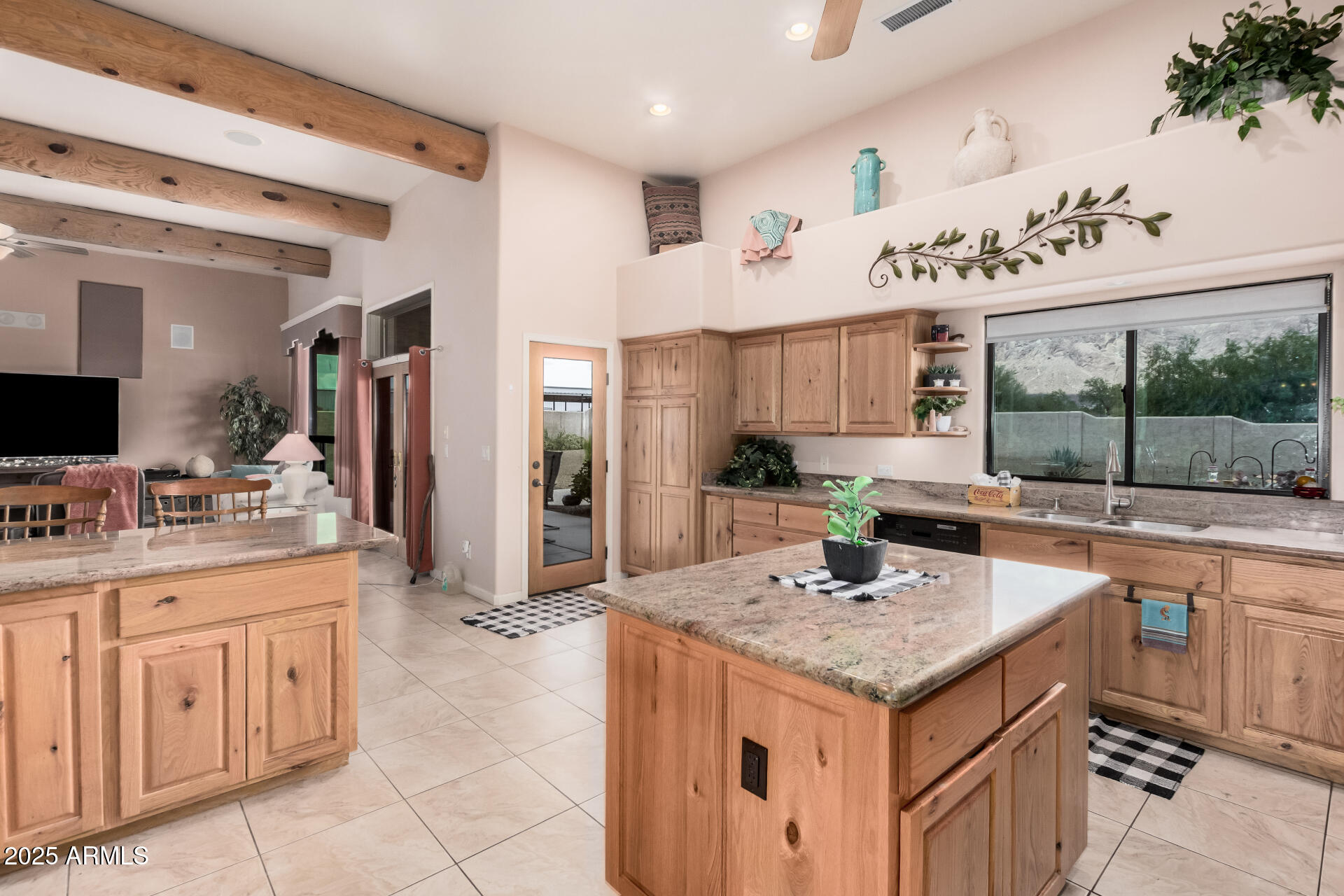 1025 North Boyd Road Apache Junction, AZ 85119 - Photo 17 of 60 a kitchen with granite countertop a sink and cabinets