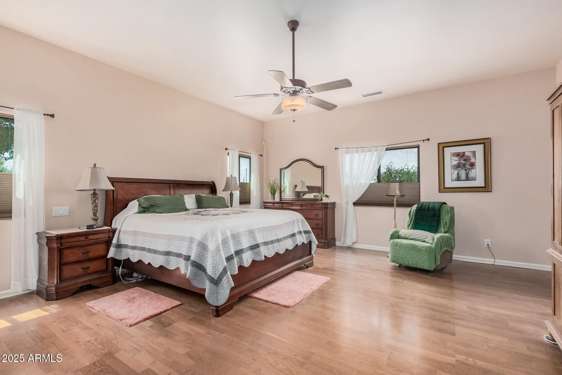 1025 North Boyd Road Apache Junction, AZ 85119 - Photo 19 of 60 a spacious bedroom with a bed a couch and a chandelier