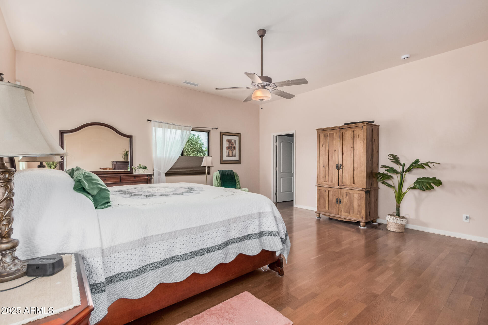 1025 North Boyd Road Apache Junction, AZ 85119 - Photo 20 of 60 a bed room with a bed and a chandelier