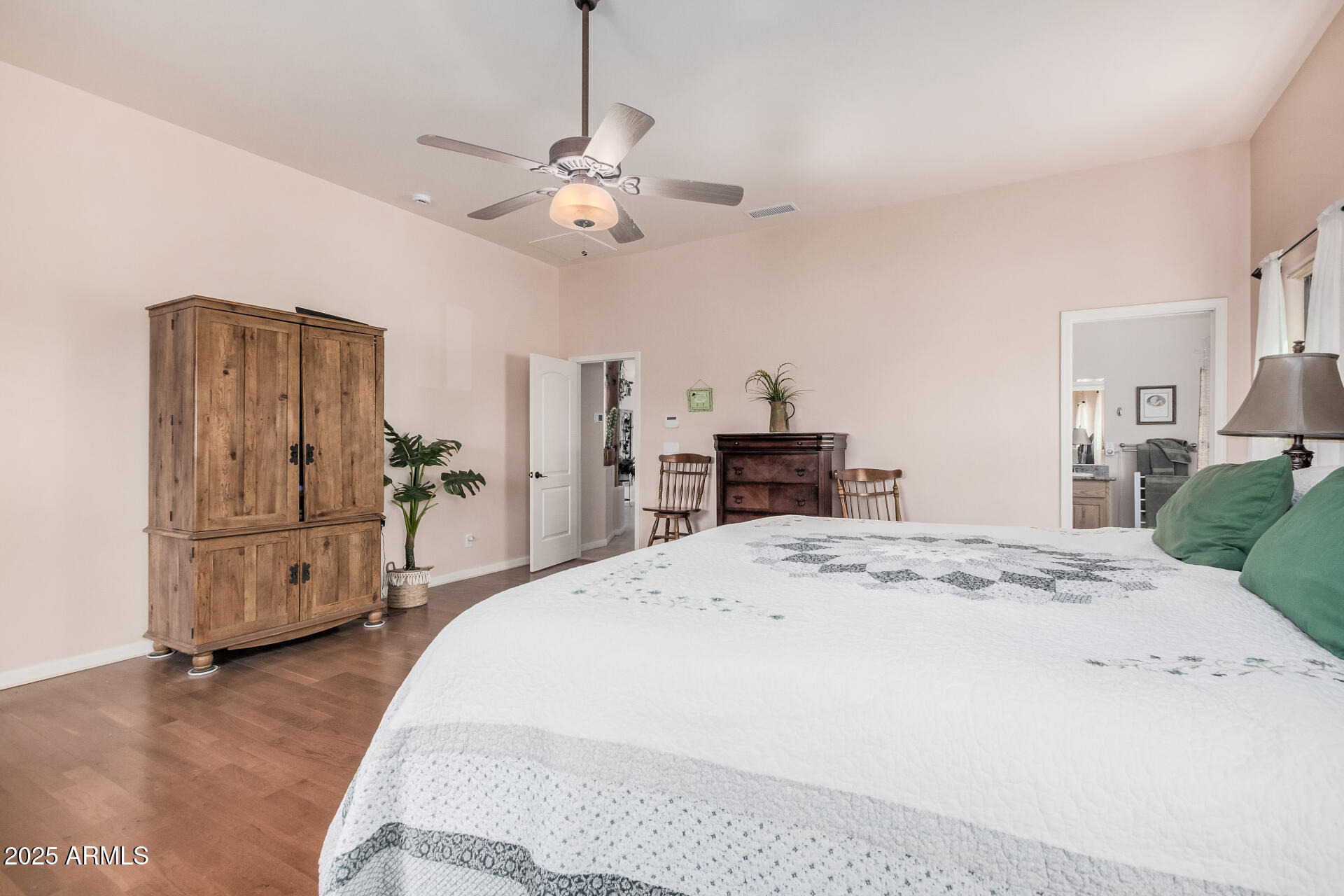 1025 North Boyd Road Apache Junction, AZ 85119 - Photo 21 of 60 a spacious bedroom with a bed and a flat screen tv
