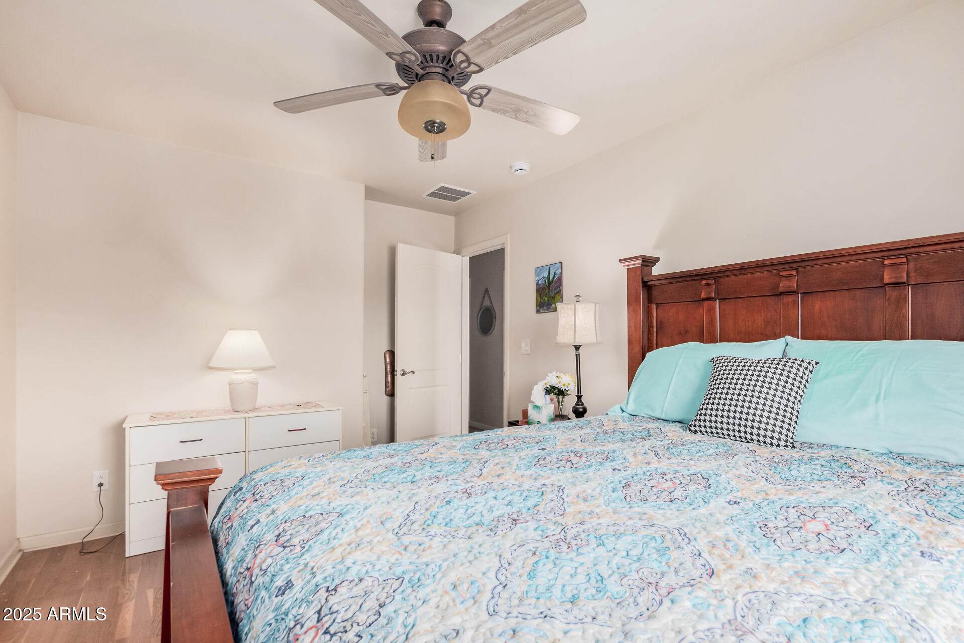 1025 North Boyd Road Apache Junction, AZ 85119 - Photo 27 of 60 a bedroom with a bed and a lamp