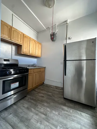 a kitchen with stainless steel appliances granite countertop a refrigerator a stove a sink and a microwave