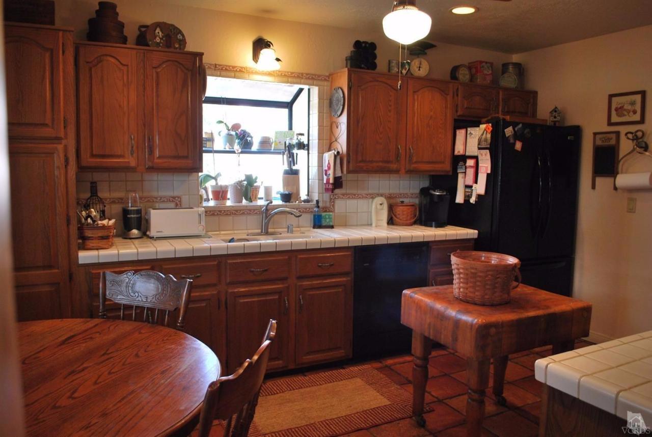 486 South Rice Road Ojai, CA 93023 - Photo 11 of 48 a kitchen with stainless steel appliances granite countertop a sink cabinets and a refrigerator