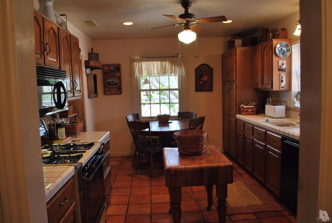 486 South Rice Road Ojai, CA 93023 - Photo 13 of 48 a kitchen with stainless steel appliances granite countertop a stove a sink dishwasher and a refrigerator with wooden floor