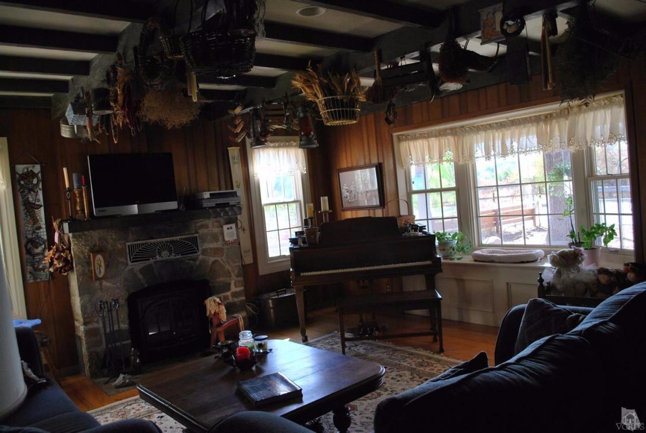 486 South Rice Road Ojai, CA 93023 - Photo 18 of 48 a living room with furniture a flat screen tv and a fireplace