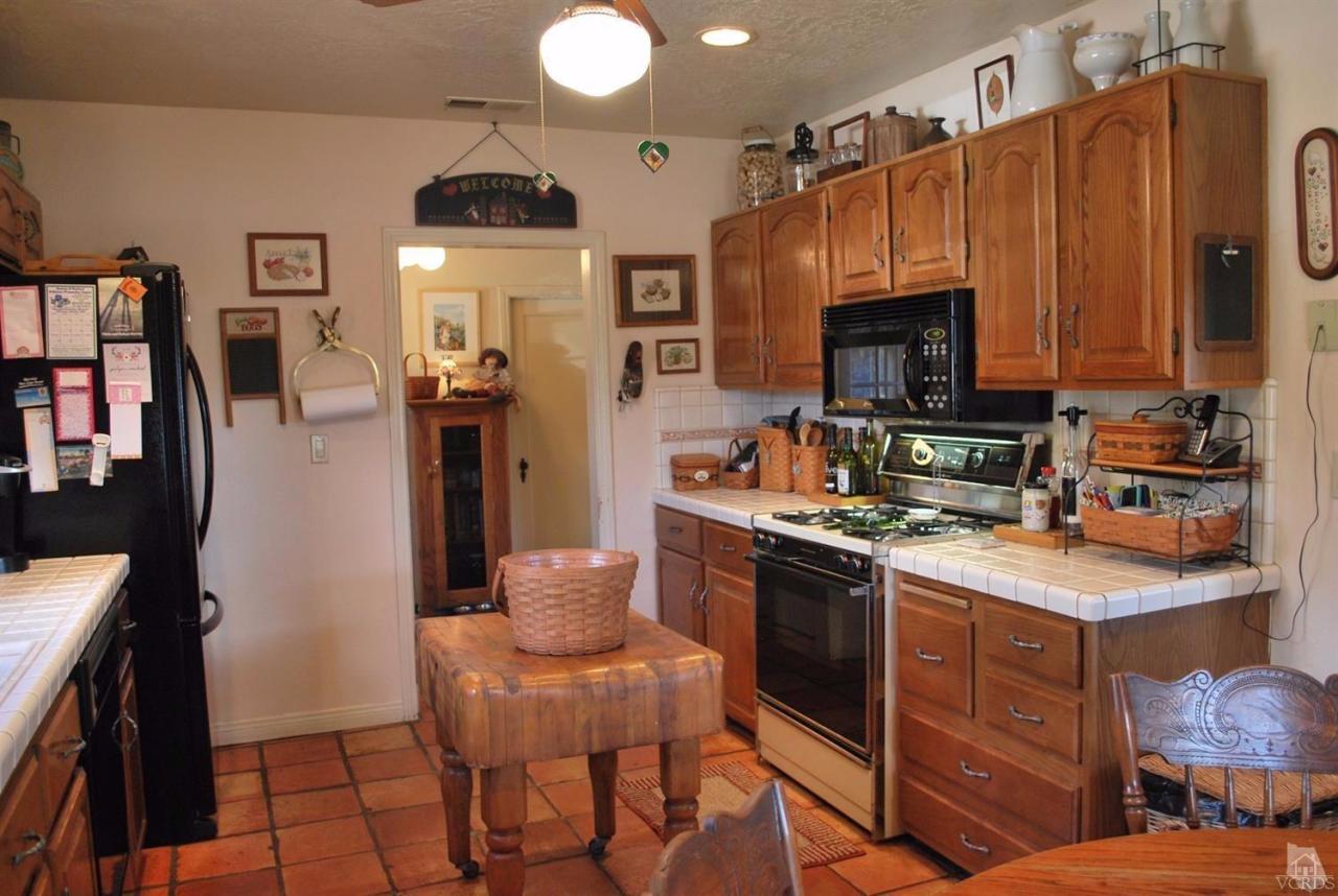 486 South Rice Road Ojai, CA 93023 - Photo 10 of 48 a kitchen with stainless steel appliances a stove a sink dishwasher and a refrigerator