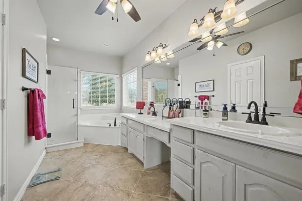 a large kitchen with a sink dishwasher a dining table and chairs with wooden floor