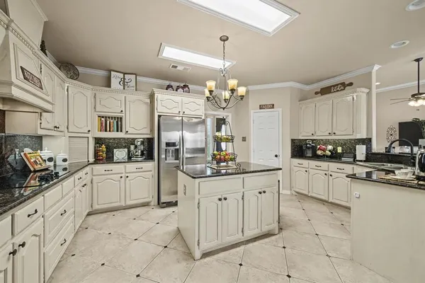 a kitchen with white cabinets and white appliances