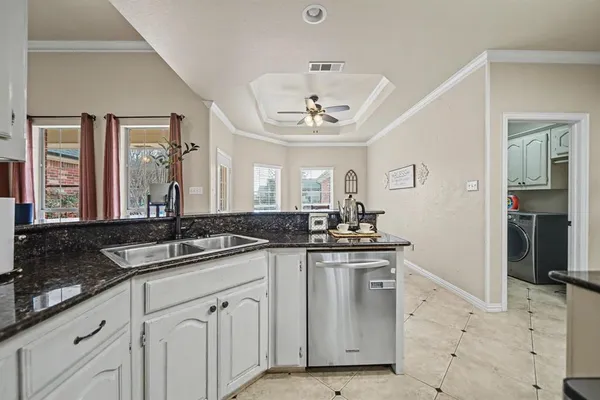 a kitchen with granite countertop a sink and cabinets