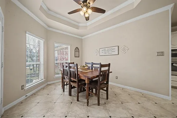 a view of a dining room with furniture and a chandelier