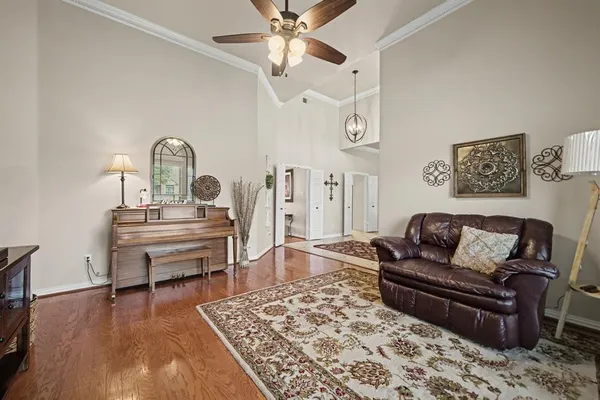 a living room with furniture and wooden floor