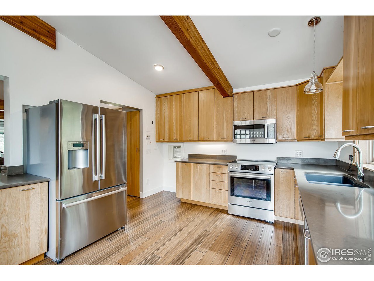 1112 Gapter Road Boulder, CO 80303 - Photo 16 of 40 a kitchen with stainless steel appliances granite countertop a refrigerator a sink dishwasher a stove with wooden floor