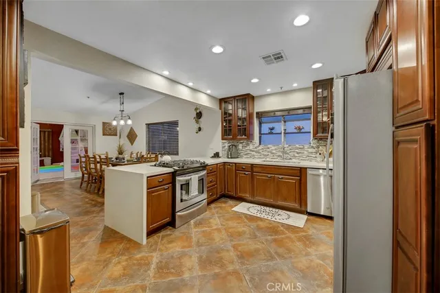 a large kitchen with stainless steel appliances granite countertop a large counter top and a stove