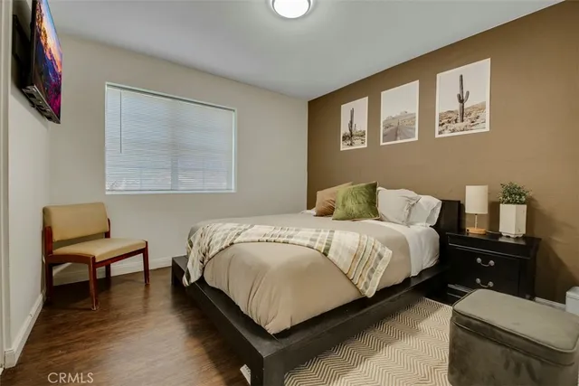 a bedroom with a bed and a chair