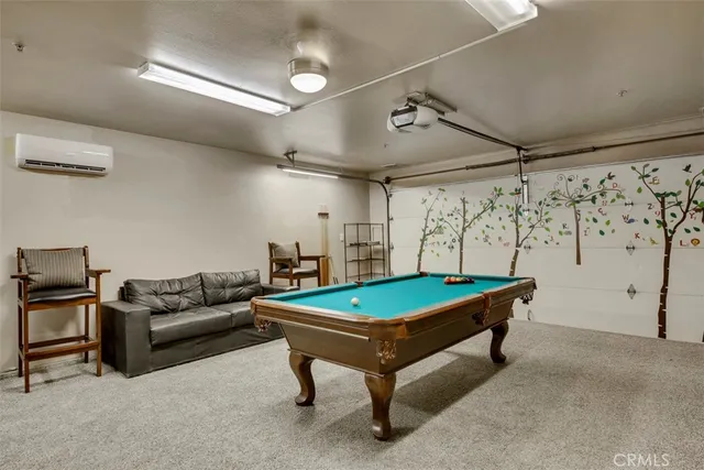 a living room with furniture and pool table
