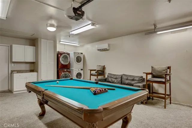 a room with pool table and windows