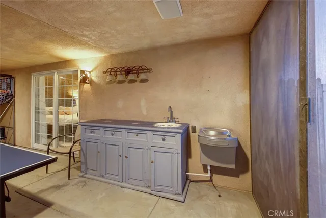 a spacious bathroom with a granite countertop sink and a mirror