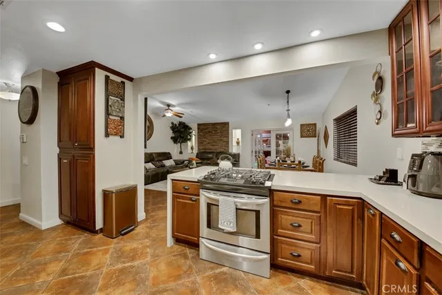 a kitchen with stainless steel appliances granite countertop a stove and a sink