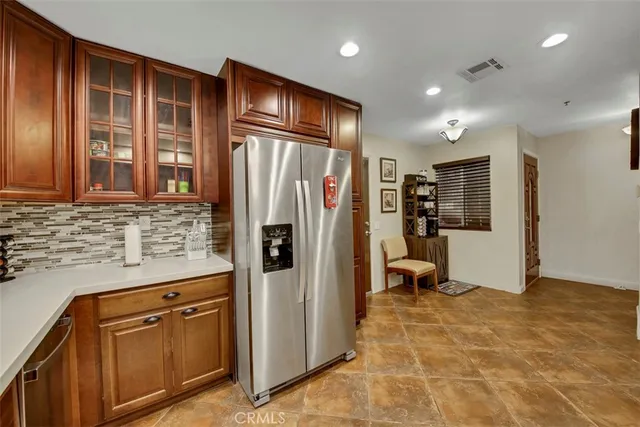 a kitchen with stainless steel appliances granite countertop a refrigerator and a sink