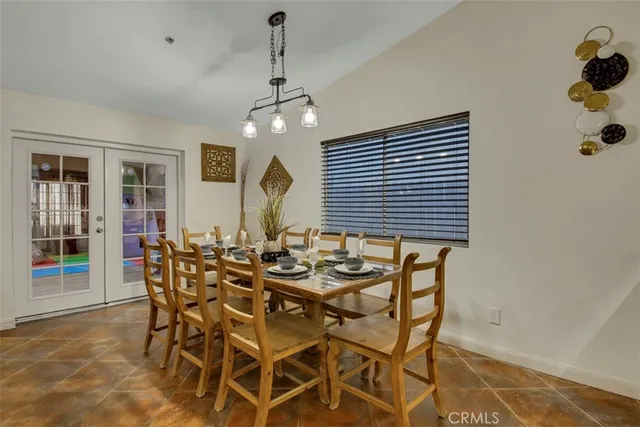 a view of a dining room with furniture and chandelier