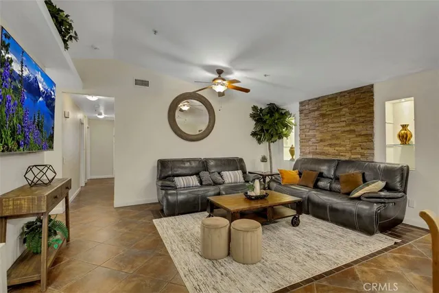 a living room with furniture a rug and a window