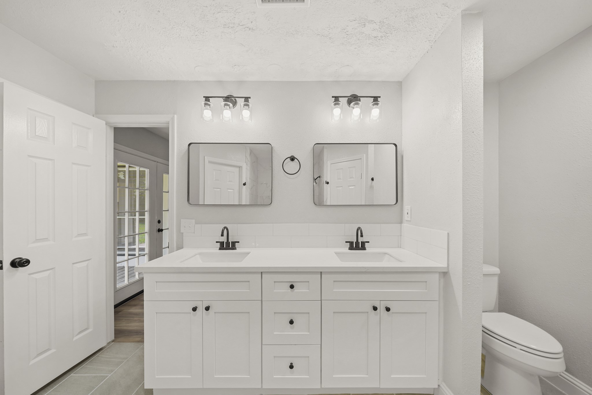 3623 Peachstone Place Spring, TX 77389 - Photo 18 of 20 a bathroom with double vanity sink a mirror and a toilet