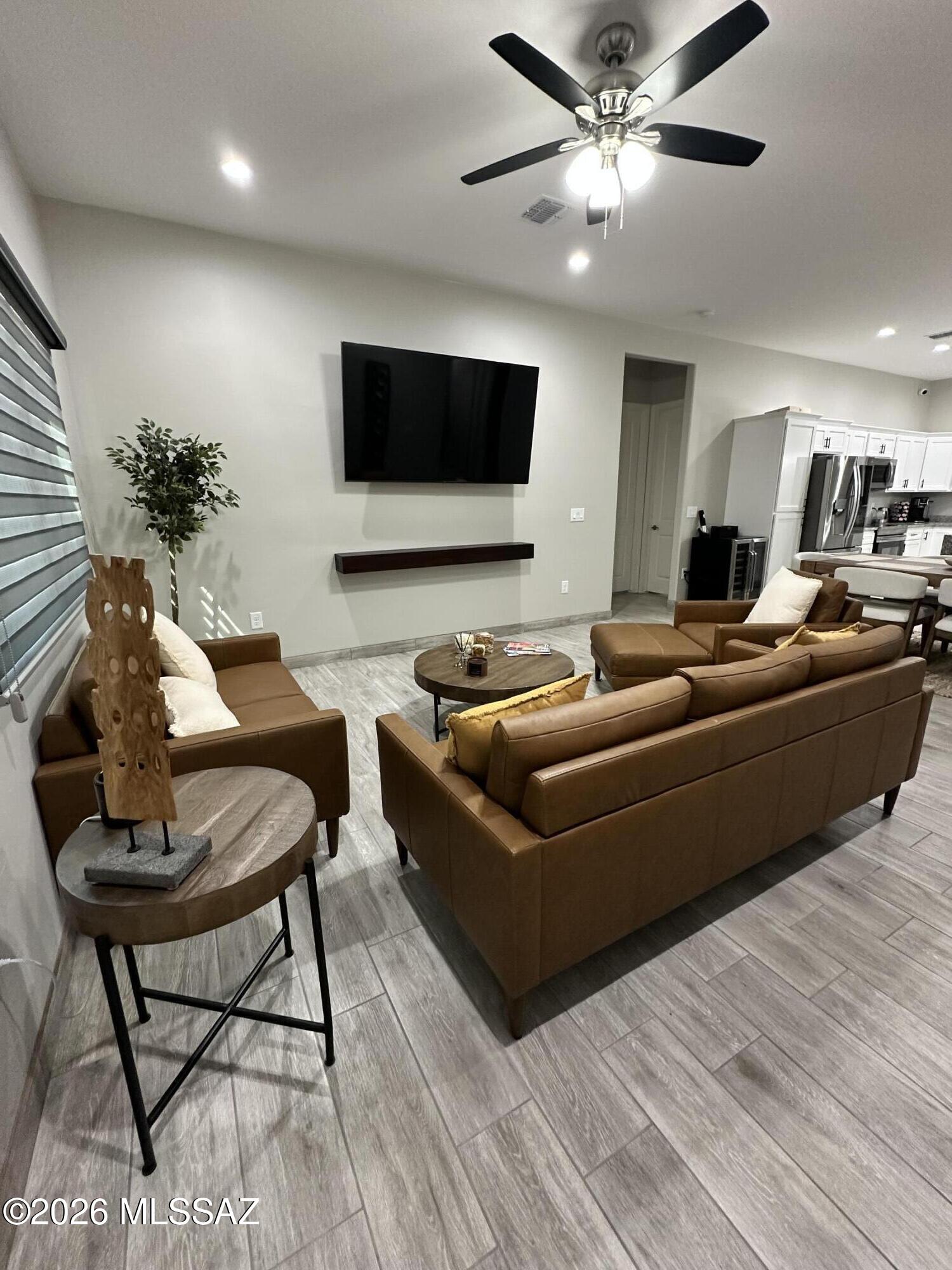 117 Ver Patria Rio Rico, AZ 85648 - Photo 6 of 28 a living room with furniture and a flat screen tv