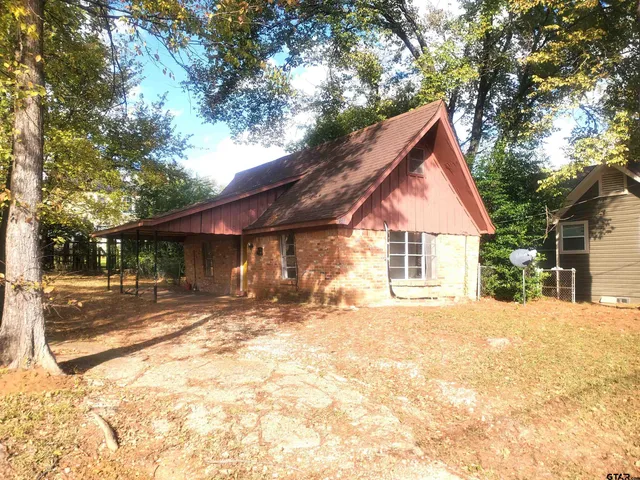 a view of a house with snow on the background
