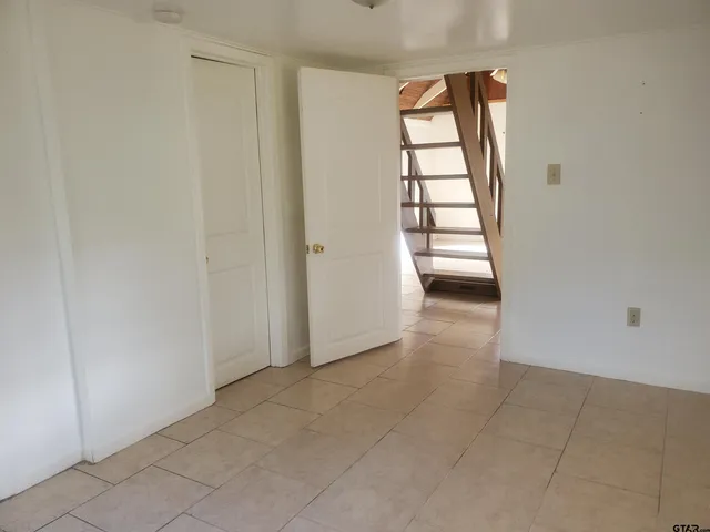 an empty room with windows and closet