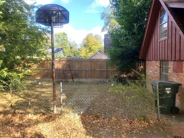 a backyard of a house with table and chairs