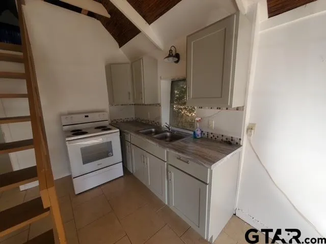 a kitchen that has a sink and a stove