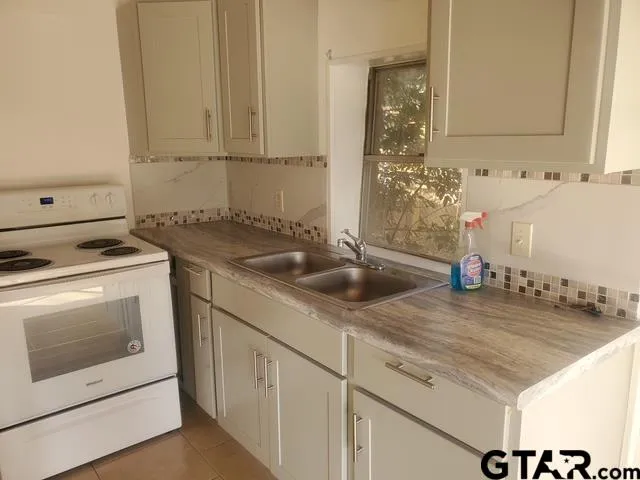 a kitchen with a sink and cabinets