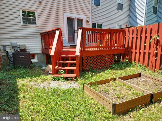 a view of an outdoor sitting area with wooden fence