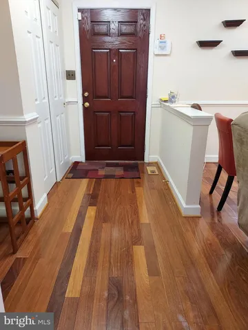 a view of a bedroom with wooden floor and furniture