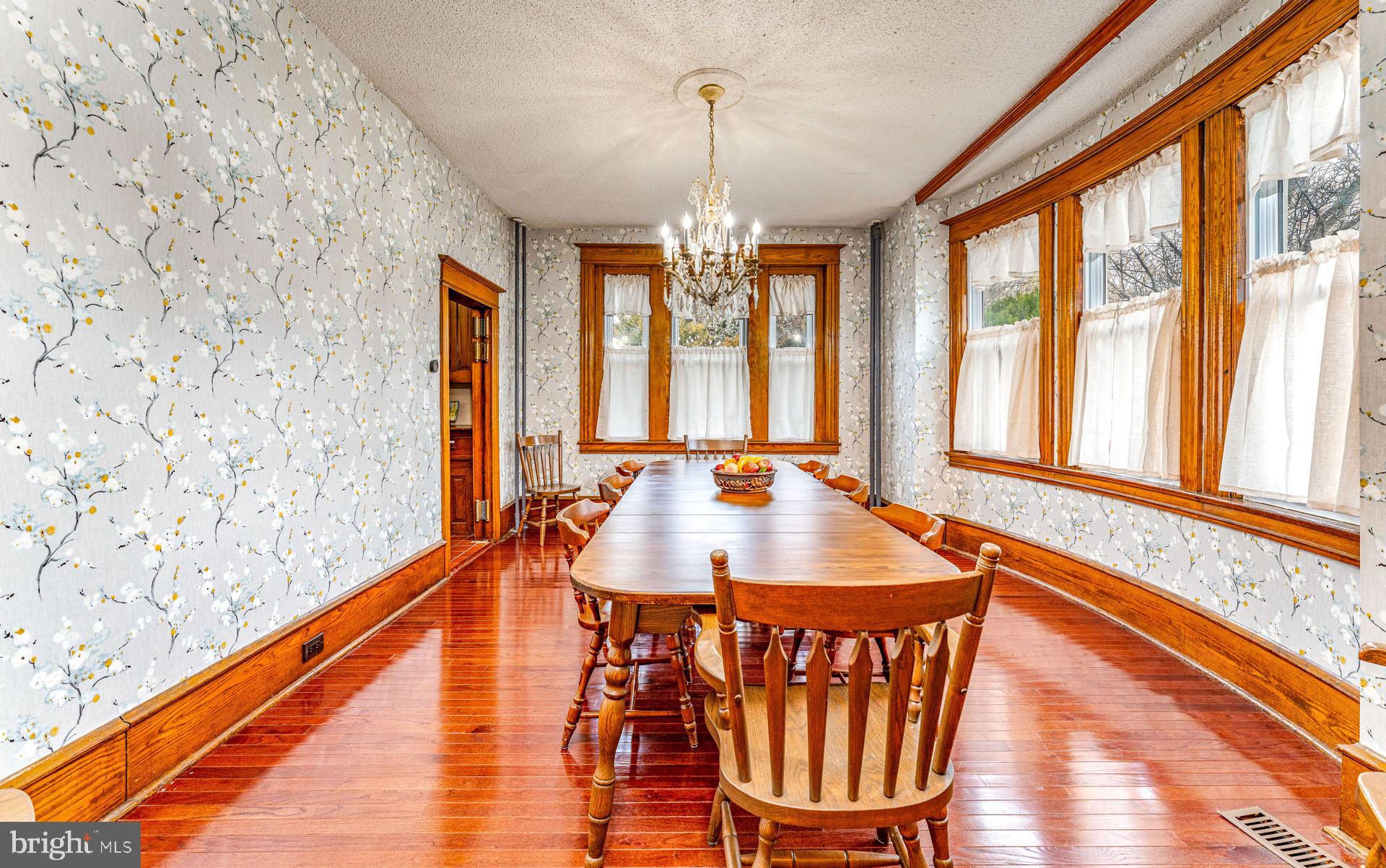 825 Bay Avenue Somers Point, NJ 08244 - Photo 12 of 37 a dining room with furniture a chandelier and wooden floor