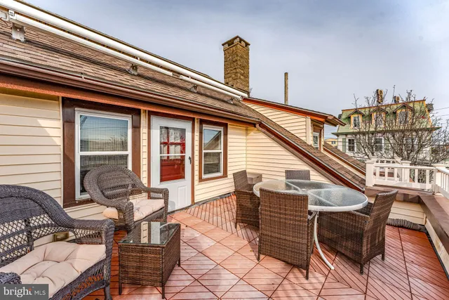 a view of a chairs and table in the balcony