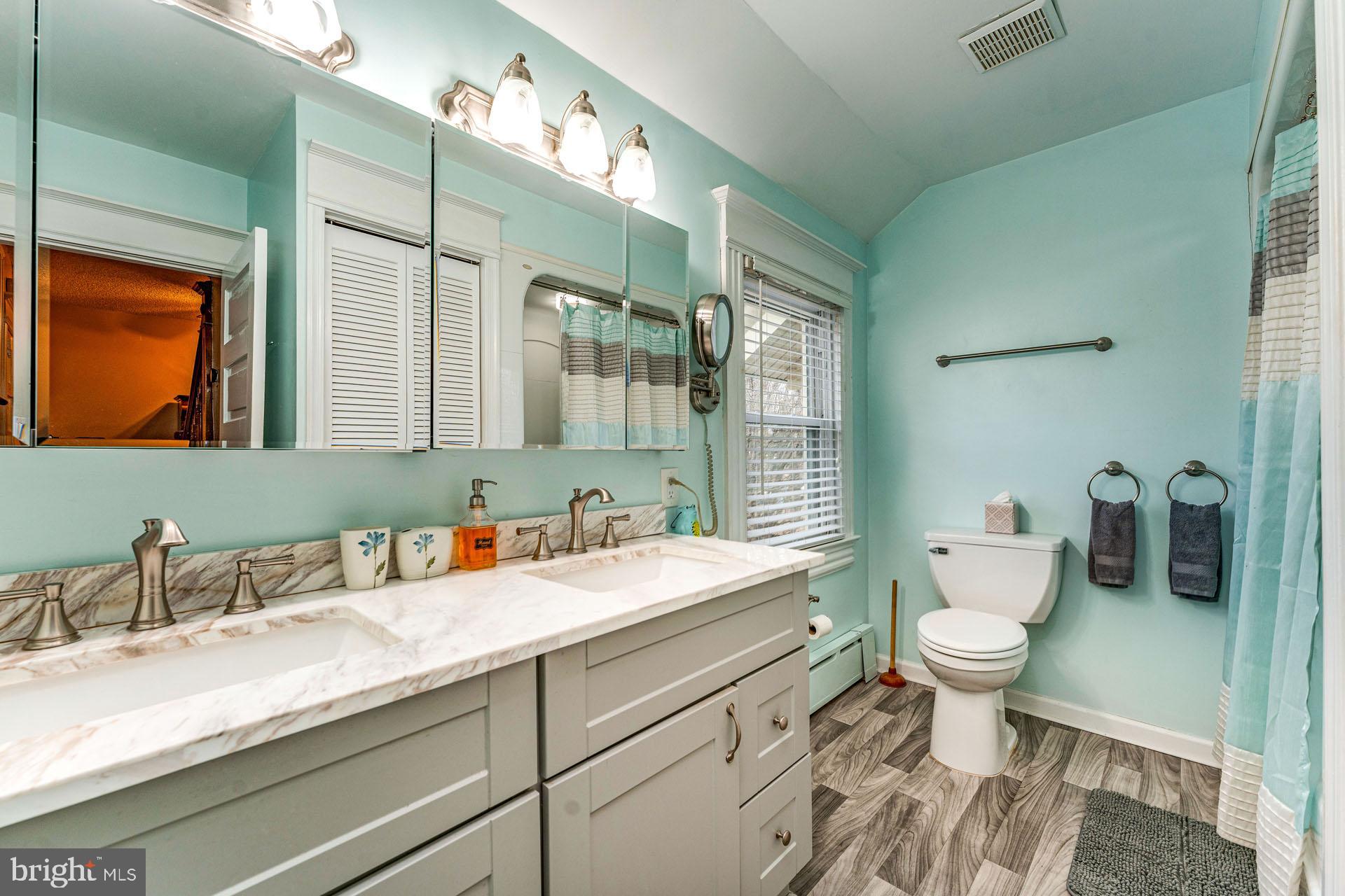 825 Bay Avenue Somers Point, NJ 08244 - Photo 22 of 37 a bathroom with a granite countertop sink mirror vanity and toilet