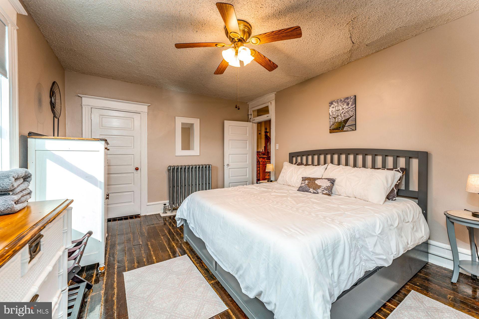 825 Bay Avenue Somers Point, NJ 08244 - Photo 23 of 37 a bedroom with a bed and a chandelier